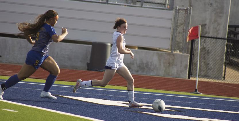 FAST PACE — Haylee Shultz (9) moves the ball towards the goal during the Lady Wildcats' Bi-District game against Chapel Hill Thursday. Shultz scored two goals, helping the Lady Wildcats to a dominant 9-0 victory. Photo by DJ Spencer