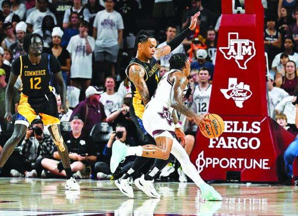 APPLYING PRESSURE — James 'Pop' Weathers (1) tries to prevent an Aggie player from scoring during Monday night's season opener. Weathers was one of three Lions to make their debut in their 78-46 loss.  Submitted Photo