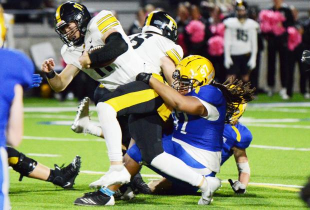 L'kyron Cork (97) tackles the Forney quarterback as he attempts to run through the line. Cork had four total totals, three of which where solo.