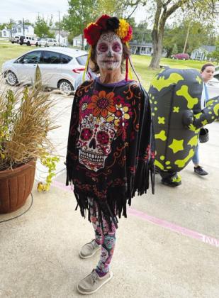 Costumed in Dia de los Muertos sugar skull mask is Wesley House housekeeper Jean Fouse.