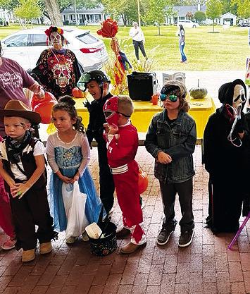 Children line up for Wesley House's costume contest. Staff photos by Enola Gay Mathews