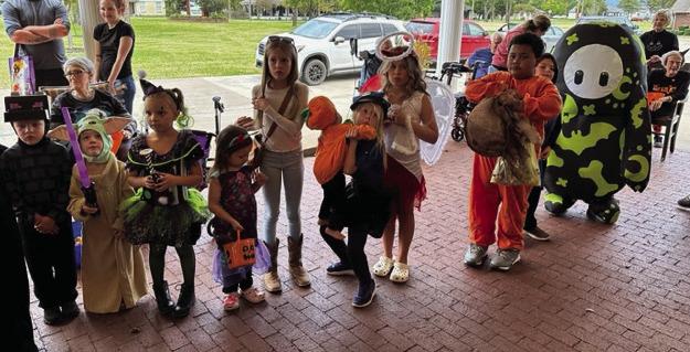 Children line up for the costume contest during Wesley House's Halloween carnival.