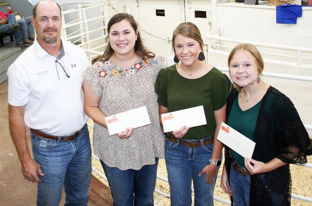 Three of the nine 2022 Northeast Texas Beef Improvement Organization (NETBIO) college scholarship recipients were at the NETBIO cattle sale Friday to receive their awards. Presenting the awards was Kregg Slakey, left. Receiving the scholarships, from left, are Makenzie Newton of New Boston, Brook Jester of Bivins, and Ashlyn Sanders of Leesburg. Submitted photo