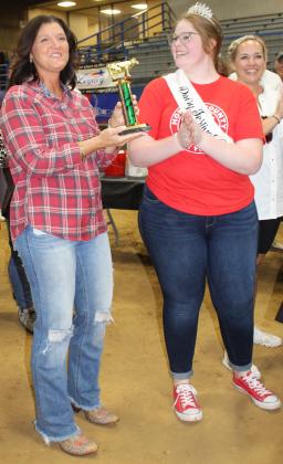 2022 Dairy Festival Queen Colbie Glenn presents Jennifer Graves with the trophy for collecting the most milk in their daughter, Addison Graves' pail during the Bobby McDonald Milking Contest Saturday, June 10, 2023