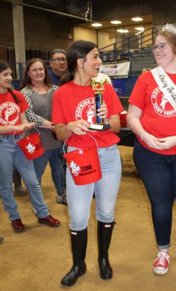 2022 Dairy Festival Queen Colbie Glenn congratulates 2023 contestant Tomi Pirtle, who won first place in the Milking Contest, collecting 63.1 ounces (about a half gallon) of milk in her pail.
