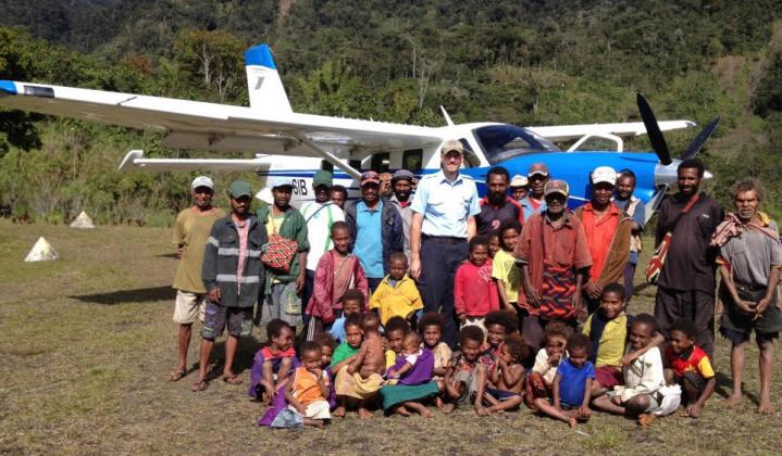 MISSION PILOT — Jason Brewer's (center) interest in flying began early in life, then blossomed into mission work in Papua, New Guinea which he and his wife have shared in for a decade. His plane provides transportation and brings needed supplies. Courtesy photo