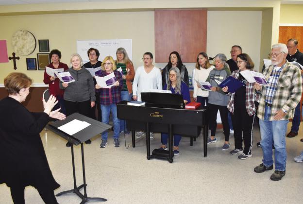 WORKING HARD —Final rehearsals are taking place for the NETexas Choral Society's 'Silver Bells' Christmas Concert to be staged in the SSHS Auditorium of the Civic Center in two performances only: Saturday, Dec. 3 at 7 p.m. and Sunday, Dec. 4 at 2 p.m. Tickets are available at local banks, from Choral Society singers, and at the door. This is the 25th Anniversary concert. Staff photo by Don Wallace