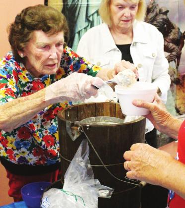 Shirley Brock (left) received first place for her strawberry-peach homemade ice cream. She was more than happy to dish it out Friday at the annual Senior Ice Cream Freeze-Off at the Sulphur Springs Senior Citizen Center. A total of 13 different flavors were entered by several individuals and community health agencies. Staff photo by Ashley Colvin