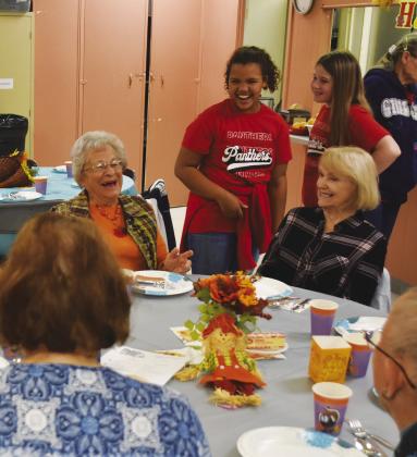 SO FUNNY — Members of the North Hopkins Elementary Beta group share laughs with the seniors Wednesday at a special Thanksgiving/Friendsgiving event sponsored by City National Bank at the Sulphur Springs Senior Citizen Center.
