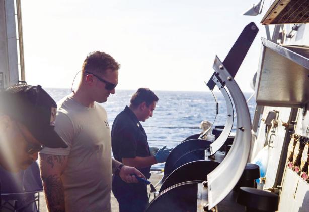 PHILIPPINE SEA (Jan. 21, 2024) — US Navy Chief Master-at-Arms Jarrett Covington, center, from Miller Grove, Texas, prepares food for a steel beach picnic aboard Arleigh Burke-class guided-missile destroyer USS Kidd (DDG 100). Kidd is assigned to Carrier Strike Group ONE and deployed to the U.S. 7th Fleet area of operations in support of a free and open Indo-Pacific. U.S. Navy photo by Mass Communication Specialist 2nd Class Mason Congleton