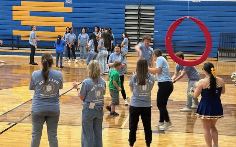 Cheerleaders, Blue Blazes and student athletes help Special Needs students to enjoy playing and winning  at free throw, batting, and other games