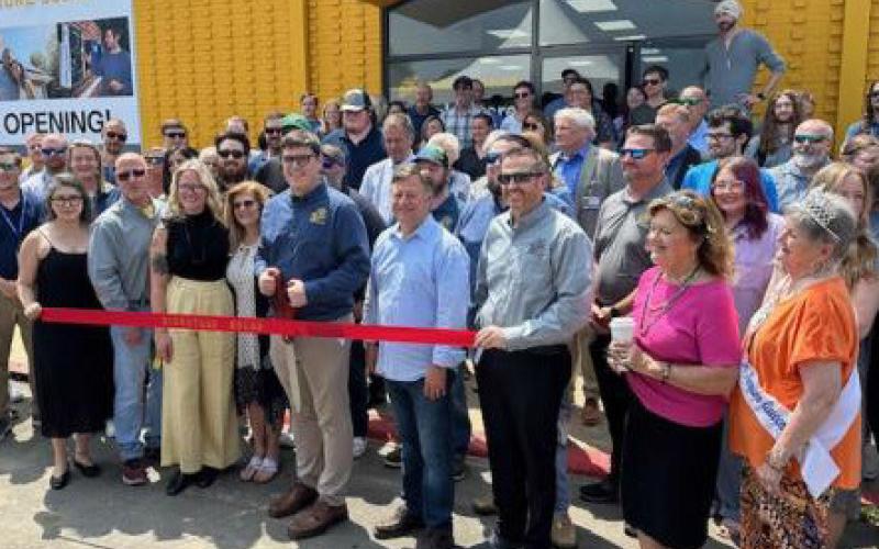 James Showalter prepares to cut the ribbon for the opening of Signature Solar in Sulphur Springs.