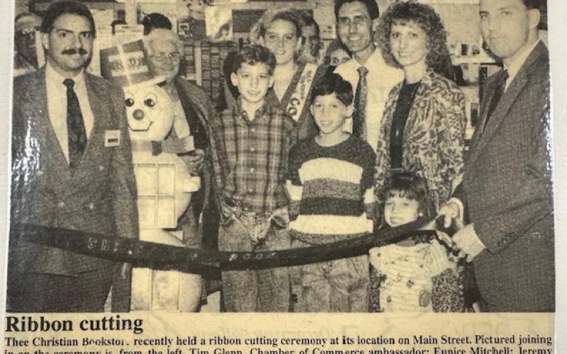 A newspaper clipping for the grand opening of the Christian bookstore under the new ownership of Garry and Gena Jordan in 1990.
