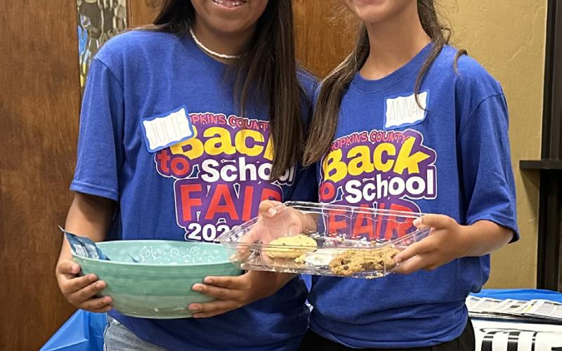 Julie Santana and Anna Claire Newsom volunteer, handing out sweet treats, at the 2023 CANHelp Back to School Fair July 27.