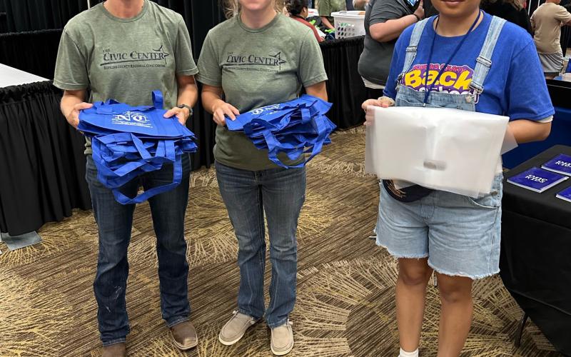 Civic Center staff members Rachel Juranek and Jaden Bowen, along with CANHelp staff member Pamela Alonso, volunteer with News-Telegram in distributing bags.
