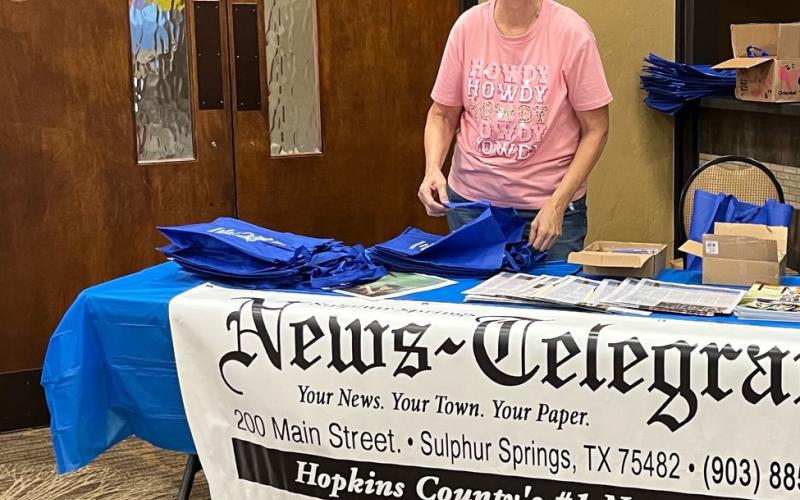 Community Liaison Enola Gay Mathews shares a laugh enjoys meeting new people while representing the Sulphur Springs News-Telegram, Country World and Down Home East Texas at the CANHelp Back to School Fair.