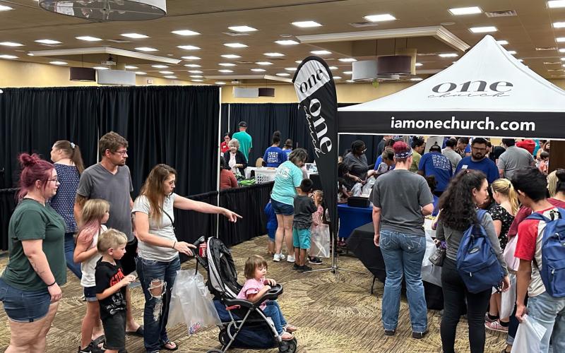 Families and youth stop by the One Church booth during the CANHelp Back to School Fair July 27.