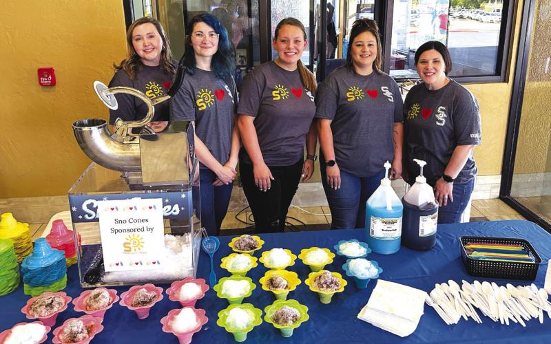 Signature Solar team members Madison Dearmore, Taylor Brooks, Jayla Talley, Emma Cooley and Brianna Schroeder serve two different flavors of sno cones.