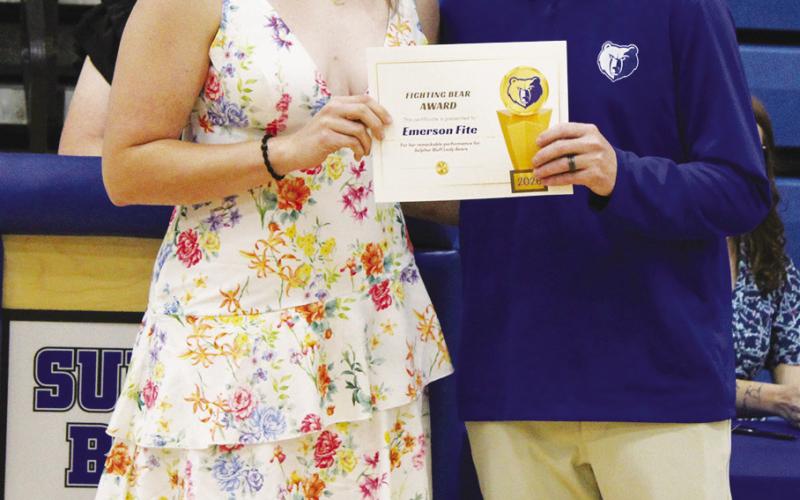 Emerson Fite (left) was also a co-recipient of the Girls Fighting Bear Award, given to the hardest-working female athlete. Presenting the award is Coach Casey Riddle.
