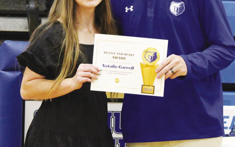 Natalie Carrell (left) was a co-recipient of the Female Heart and Hustle Award, given to the female athlete who brings unmatched energy, passion, selflessness and work ethic. Coach Casey Riddle presented the award.