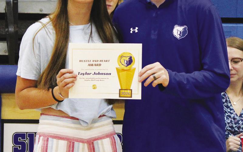 Taylor Johnson (left) was also a co-recipient of the Female Heart and Hustle Award, given to the female athlete who brings unmatched energy, passion, selflessness and work ethic. Coach Casey Riddle presented the award. Johnson also earned MVP honors for girls cross country and girls track and field.
