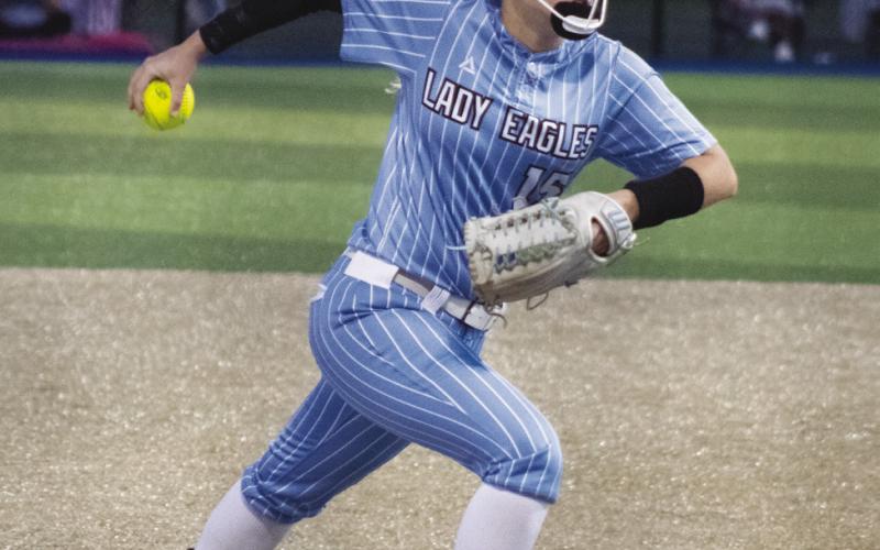 Lexie Rainey (15) steps into her delivery during Game 3 of the Lady Eagles' Area Playoff series against Overton Saturday. Rainey pitched a one-hit shutout in the Lady Eagles' 5-0 victory, striking out seven batters and only walking one. She also batted 1/3 from the plate. Staff Photos by DJ Spencer
