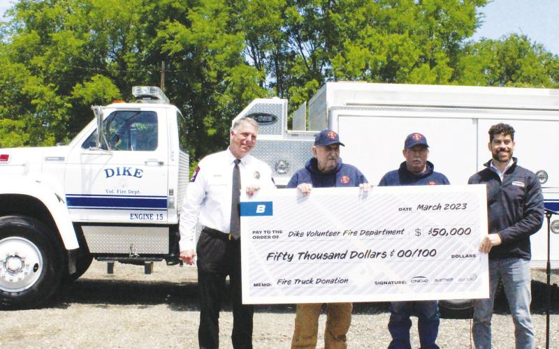 CHECK GIVEN — Hopkins County Fire Marshal Andy Endsley joins Dike VFD Chief AG Sandifeer and Assistant Chief Joel Pace in the formal presentation of a $50,000 check by Ryan Economy, the lead developer of the Hopkins Solar Project, from ENGIE North America, Blattner and Alpin Sun for the purchase of a fire truck for Dike VFD. Staff photo by Faith Huffman