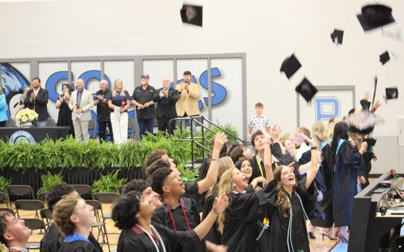 Pickton High School Senior Class of 2026 toss their caps to celebrate their