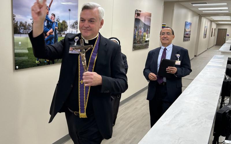 Father Justin Wylie sprinkles holy water throughout the new CHRISTUS Trinty Clinic on Airport Road beside CHRISTUS Mother Frances Hospital-Sulphur Springs. He is accompanied by Andy Navarro with Trinity Mother Frances Health System. CHRISTUS Health photo