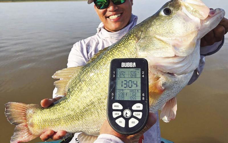 Lawrence Lee of Tolar with a 13.04-pound beauty caught on July 19 at Lake J.B. Thomas near Snyder. Lee has caught two other bass over 13 pounds at the lake since January and 11 other fish between eight and 10.4 pounds since June that are documented Toyota Share-Lunkers. Most were caught while fishing with guide Christian Gladfelter. Courtesy Photo/ Slaunched Guide Service
