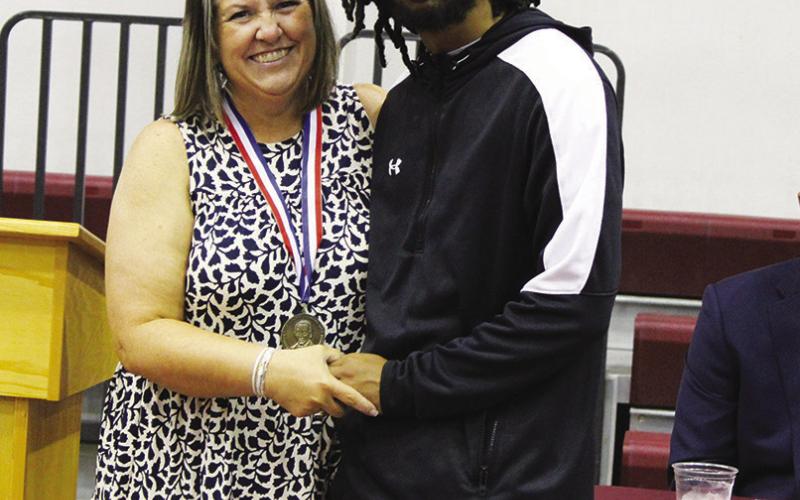 Dakari Johnson (right) received a $500 scholarship from the Texas Retired Teachers Association. He is pictured with Misty Sawyer.