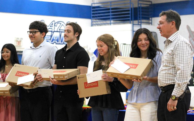 (Far right) Jason Frazier from the First National Bank of East Texas presented Mya Ramos, Daniel Gonzalez, Mason Friddle, Shelbi Griffin and Ana Servin Chromebooks during the SBHS senior awards on May 11.