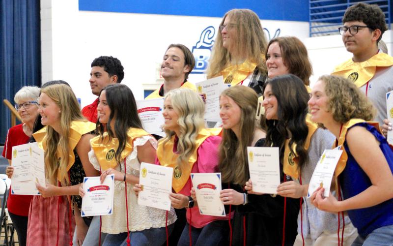 (Back row) Ricardo Estrada, Mason Friddle, Hunter Wells, Mabry Huie and Daniel Gonzales, (front row) Mya Ramos (behind), Zaylee Peyton, Kinder Stanley, Jadi Jones, Shelbi Griffin, Ana Servin and Emma Carr receive stoles for Beta Club participation and red cords if they were blood donors.