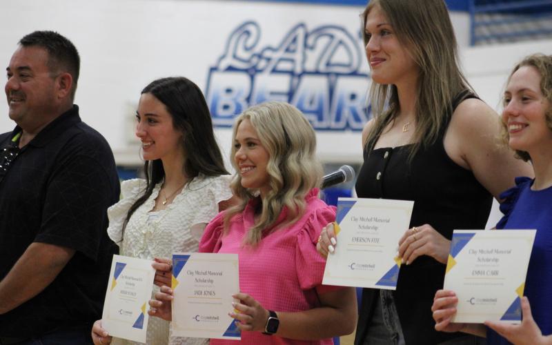 Chris Bassham awarded the Clay Mitchell FFA Memorial Scholarship to Kinder Stanley, Jadi Jones, Emerson Fite and Emma Carr.