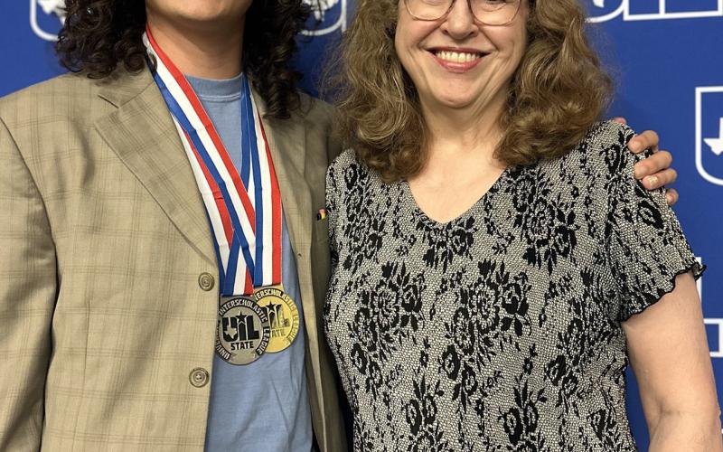 Literary criticism State champion Anthony Small opses with his coach, Gail Herman.