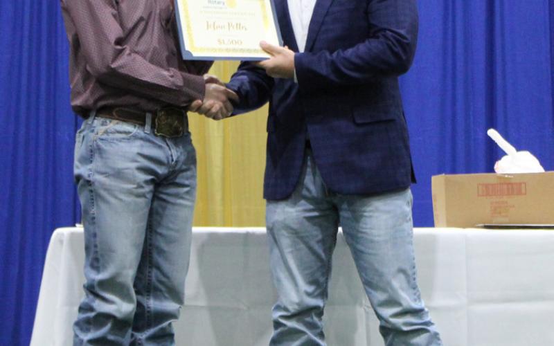 Saltillo valedictorian Tobin Potter receives a $1,500 Rotary Club Scholarship from Tyler Davison.