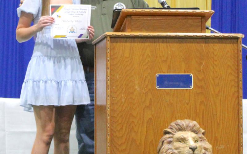 Mount Vernon Masonic Lodge member Max Caniday presents Amberly White with a $1,000 Masonic Lodge # 691 Scholarship.
