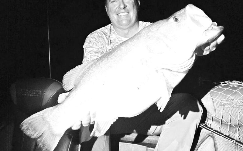 Chris Chopelas with the massive 14.09 pounder he bloated at 2 a.m. while night fishing on Aug. 15 at lake J.B. Thomas near Snyder. The angler caught and released two other double-digit and a pair of nine pounders the same night while fishing with guide, Christian Gladefelter. Photo Courtesy/slaunchedguideservice.com