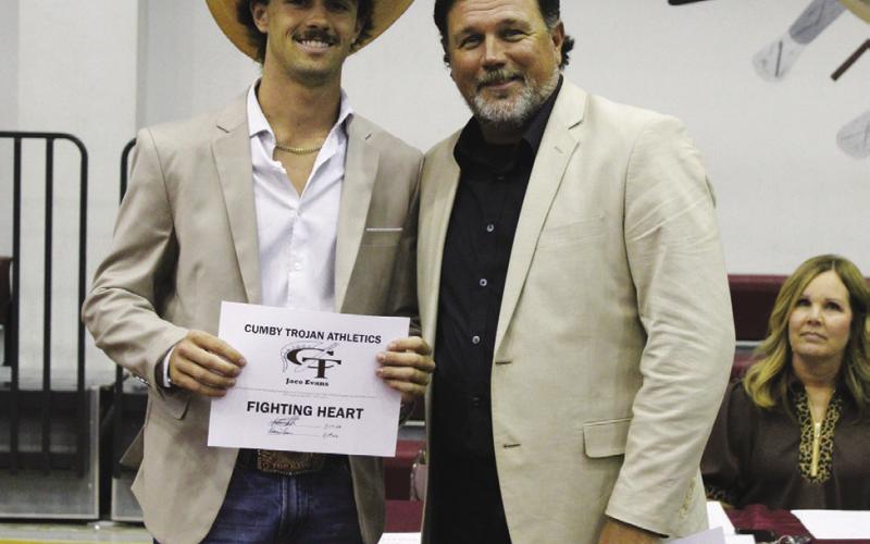 Jace Evans (left) was a co-recipient of the Male Fighting Heart Award at the Cumby Collegiate Athletic Banquet Tuesday. Presenting the award is Coach Aaron Emeyabbi. Evans also earned the Baseball MVP Award and Basketball Defensive MVP Award.