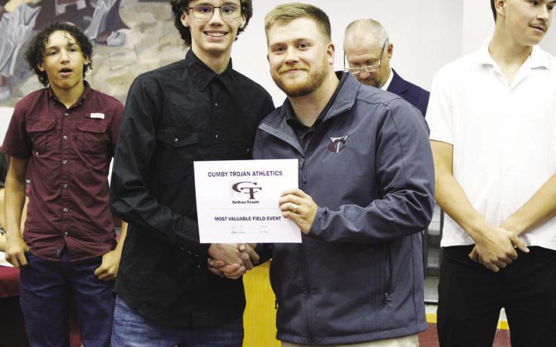 Coach Tyler Knickerbocker (right) presents Arthur Truitt with the Field Events MVP Award for boys track and field.