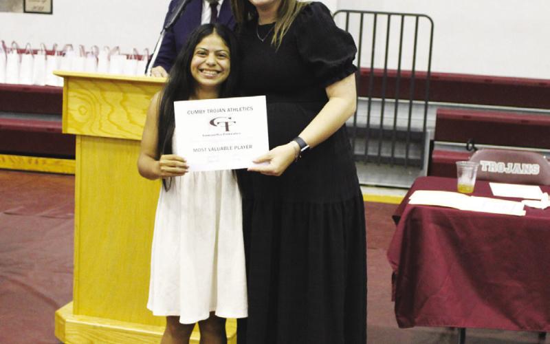 Samantha Gonzales-Tabora (left) was named Girls Cross Country MVP at the Cumby Collegiate Athletic Banquet Tuesday. Coach Macy Knickerbocker presented the award.