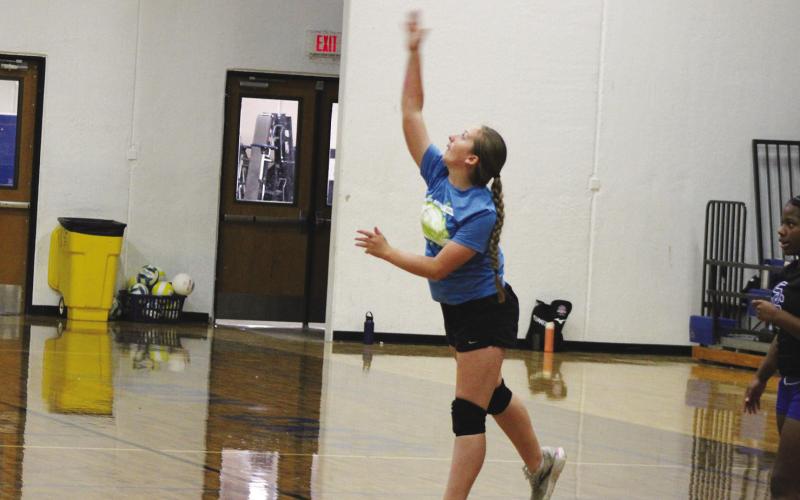 A camper launches a serve during Lady Wildcat Volleyball Camp. Serving was one of the first things taught to campers during the camp.