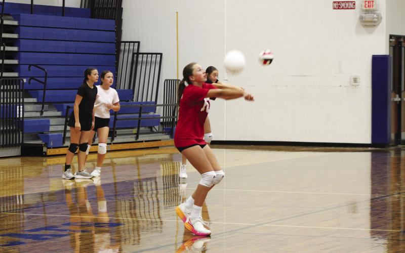 A camper passes the ball during Lady Wildcat Volleyball Camp. The passing drill helped teach campers how a rally starts in volleyball. Staff Photos by DJ Spencer