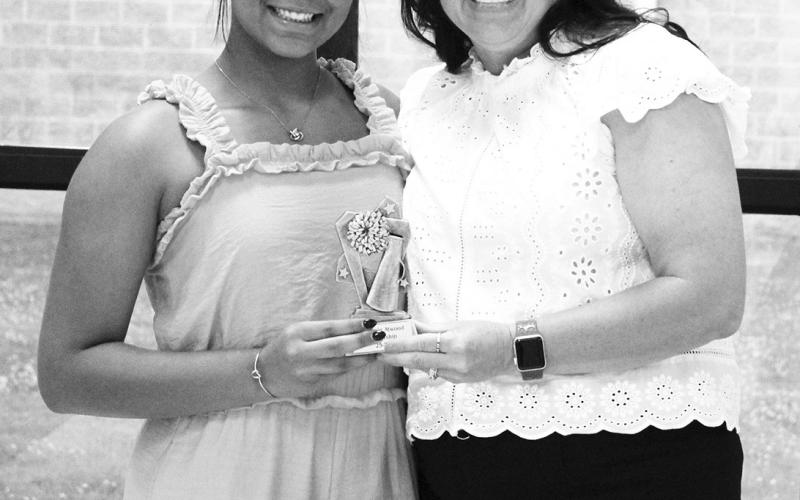 Bethanie Atwood (left) received the Superior Leadership Award for cheerleading at North Hopkins' Athletic Banquet Monday. Coach Kara Callihan presented the award.