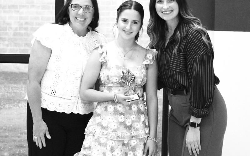 Pinzley Wells (middle) was recognized as a Regional Qualifier in track and field at North Hopkins' Athletic Banquet Monday. Coaches Kara Callihan and Rosa Schones presented the award.
