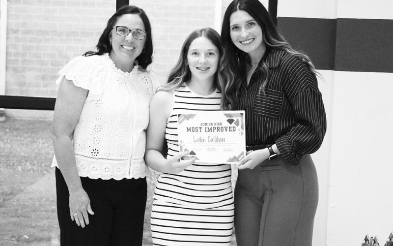 Laken Callihan (middle) was named Most Improved Runner for junior high girls track and field at North Hopkins' Athletic Banquet Monday. Coaches Kara Callihan and Rosa Schones presented the award.