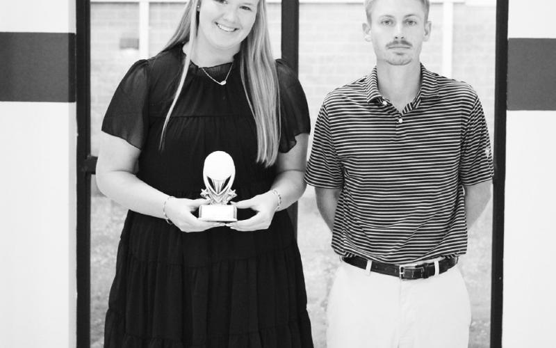 Macey Hoelscher (left) was recognized as a Regional Qualifier in golf at North Hopkins' Athletic Banquet Monday. Coach Evan Lewis presented the award.