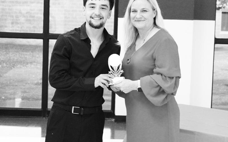 Justin Beaver (left) was recognized as a Regional Qualifier in golf at North Hopkins' Athletic Banquet Monday. Coach Danna Lewis presented the award.