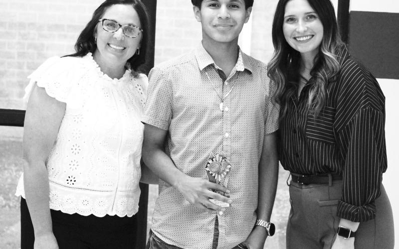 William Reina (middle) was recognized as a Regional Qualifier in cross country and track and field at North Hopkins' Athletic Banquet Monday. Presenting the award are Coaches Kara Callihan and Rosa Schones.