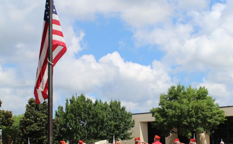 MEMORIAL DAY OBSERVANCE — Hopkins County Marine Corps League Detachment 1357 members salute the flag as the National Anthem is sung during a Memorial Day observance on the downtown square. A riderless horse was staged behind the flag. Hopkins County Military Coalition participated in the day of remembrance of those military personnel who've paid the ultimate price for our freedoms. Taps was also played during the observance, held Monday in Sulphur Springs. Staff photo by Faith Huffman